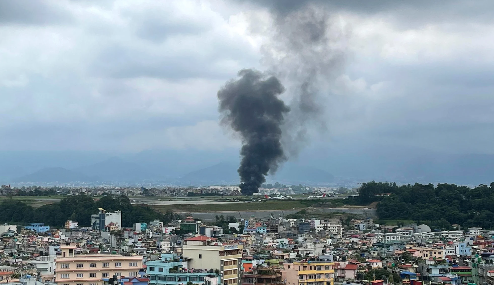 Smoke rises from the Tribhuvan International Airport after a plane crashed during takeoff in Kathmandu, Nepal on July 24, 2024 Agniia Galdanova/AP